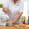 Lady using the tilt-to-pour action of the all white Uccello Kettle