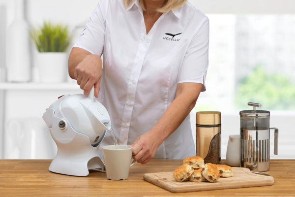 Lady using the tilt-to-pour action of the all white Uccello Kettle