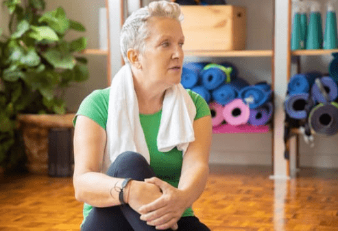Elderly woman preparing for yoga