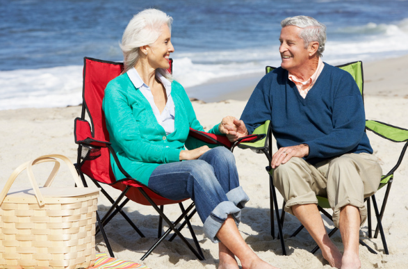 Elderly couple sitting on the beach
