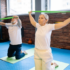 Elderly couple doing exercise with yoga mats and resistance bands