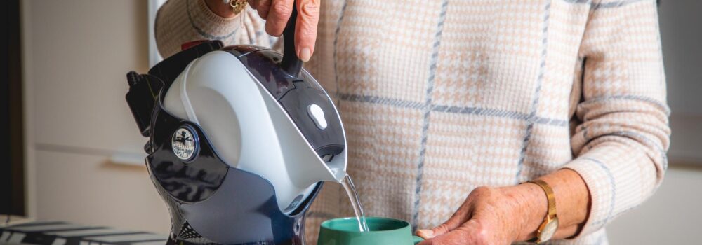 Elderly woman with Uccello Easy Pour Kettle making a cup of tea