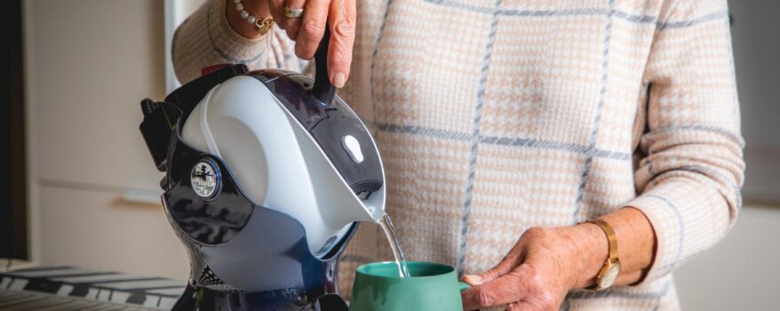 Elderly woman with Uccello Easy Pour Kettle making a cup of tea