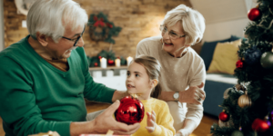 Grandparents decorating the Christmas tree with Grandchild
