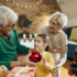 Grandparents decorating the Christmas tree with Grandchild