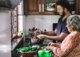 Elderly woman and son cooking in the kitchen