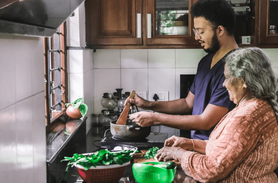 Elderly woman and son cooking in the kitchen