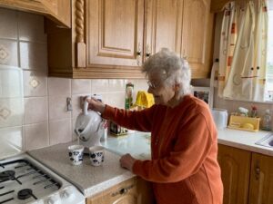 Betty O Shea making herself tea with her new Uccello Tipping Kettle