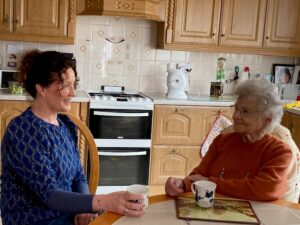 Mother and daughter talking over a cuppa in the kitchen