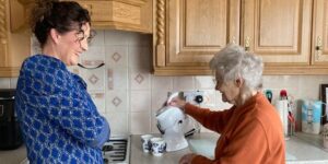 Mother and daughter in the kitchen making tea with the all white Uccello Kettle