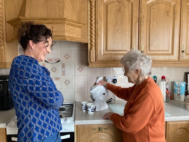 Mother and daughter in the kitchen making tea with the all white Uccello Kettle