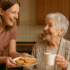 Daughter offering her mother a plate of biscuits with her cup of tea