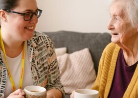 Occupational Therapist with Home visit of client enjoying a cup of tea together