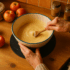Elderly woman baking in her kitchen with her mixing bowl sitting on the Uccello Grip Mat