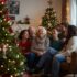 Elderly parents sitting beside the Christmas tree with their adult children laughing and smiling