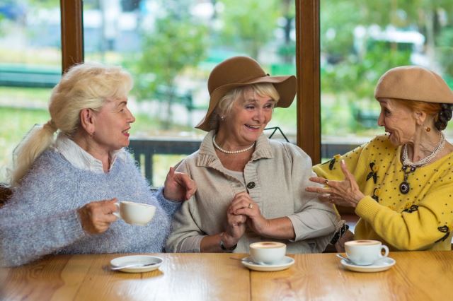 Elderly women enjoying tea together