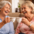 2 elderly woman chatting over a cup of tea