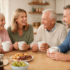 Elderly parents enjoying tea with their adult children