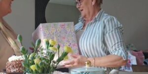 Adult daughter gifting her Mother's a large gift this Mother's Day