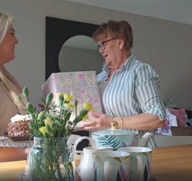 Adult daughter gifting her Mother's a large gift this Mother's Day